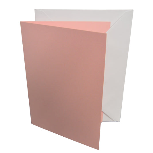 Pink card with a white envelope on a white background